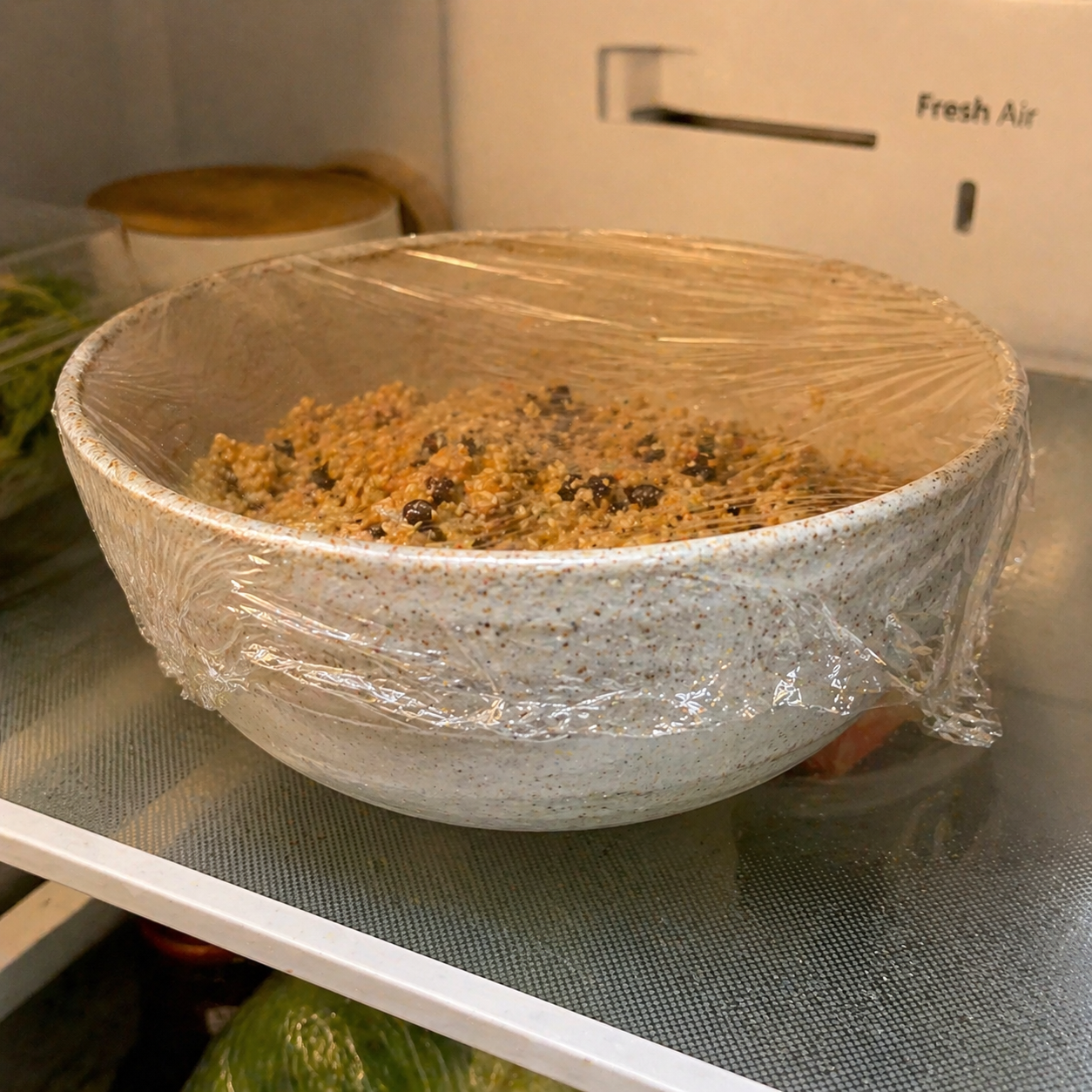 Energy ball mixture covered and chilling in the refrigerator — firming up before rolling