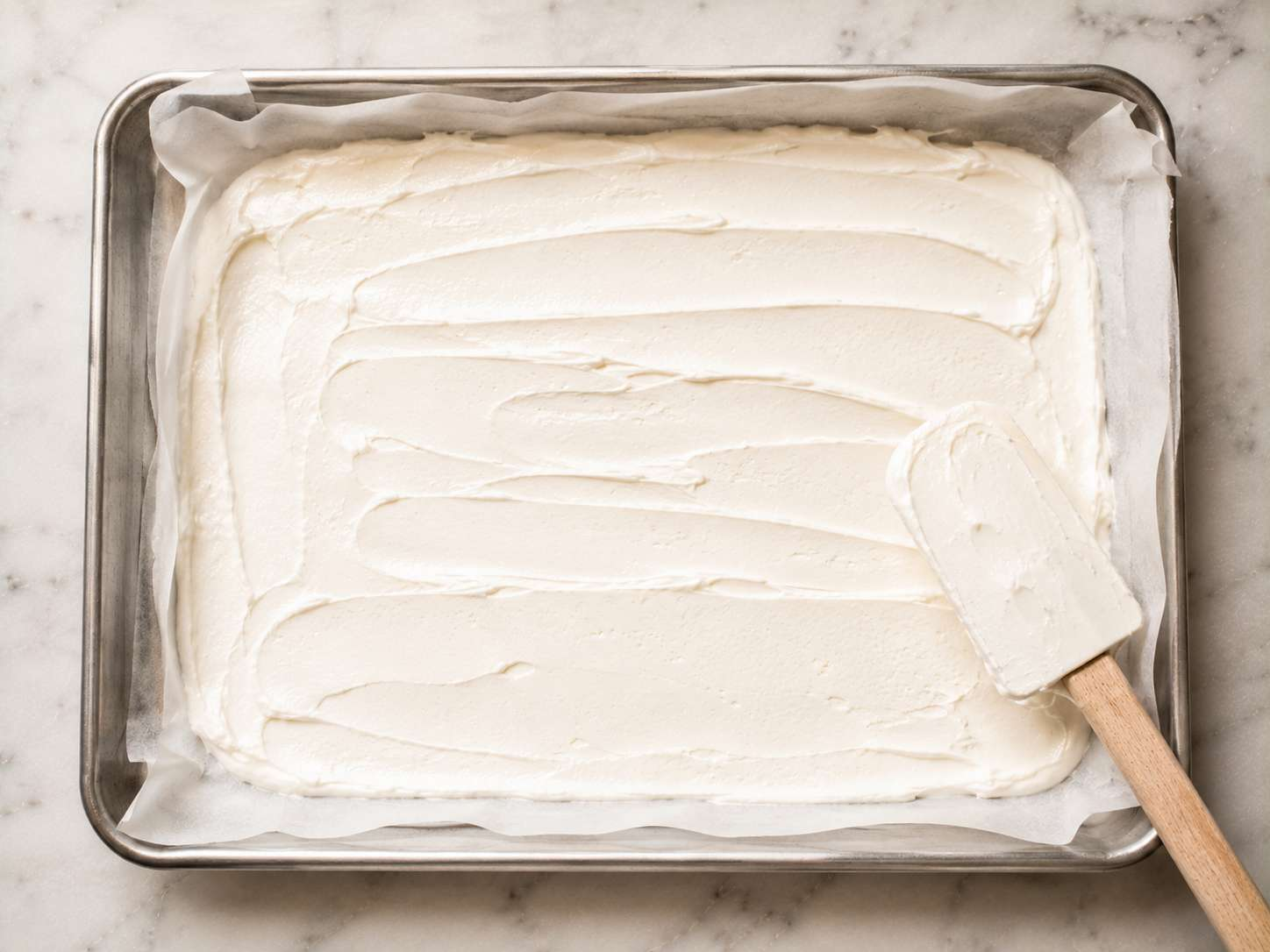 Yogurt mixture spread into an even layer on the parchment-lined baking sheet