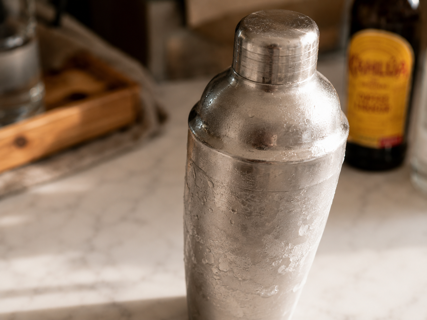 Cocktail shaker being shaken vigorously for 15–20 seconds to create the signature foam