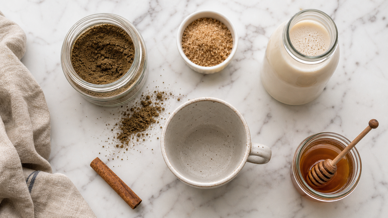 All hojicha latte ingredients laid out: hojicha powder, milk, brown sugar, cinnamon and hot water