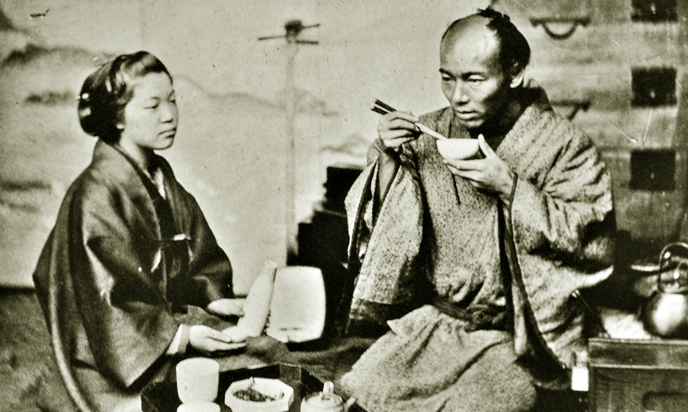 Samurai eating miso soup — a warrior in traditional dress at a simple wooden table with a bowl of miso and rice
