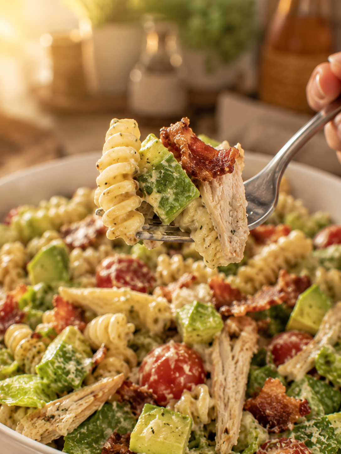 A perfect forkful of finished chicken Caesar avocado pasta salad