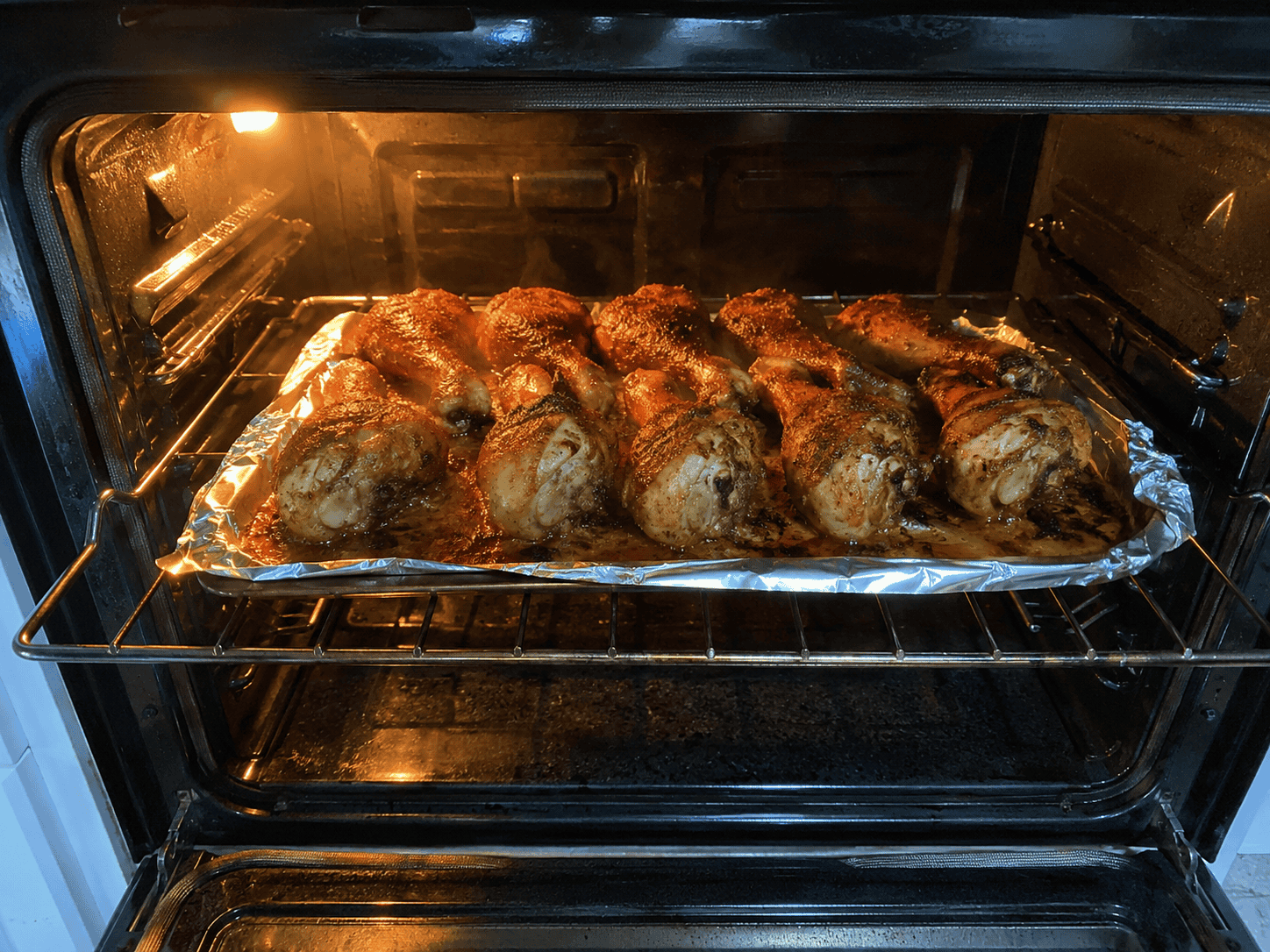 Chicken legs baking on the wire rack — deeply golden skin, checking at 35 minutes