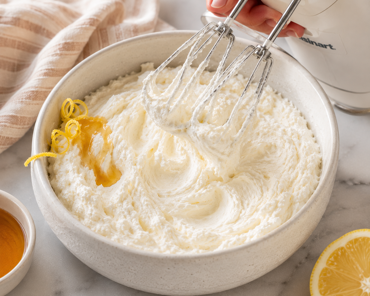 Whipping ricotta in a bowl with a hand mixer until fluffy and cloud-like