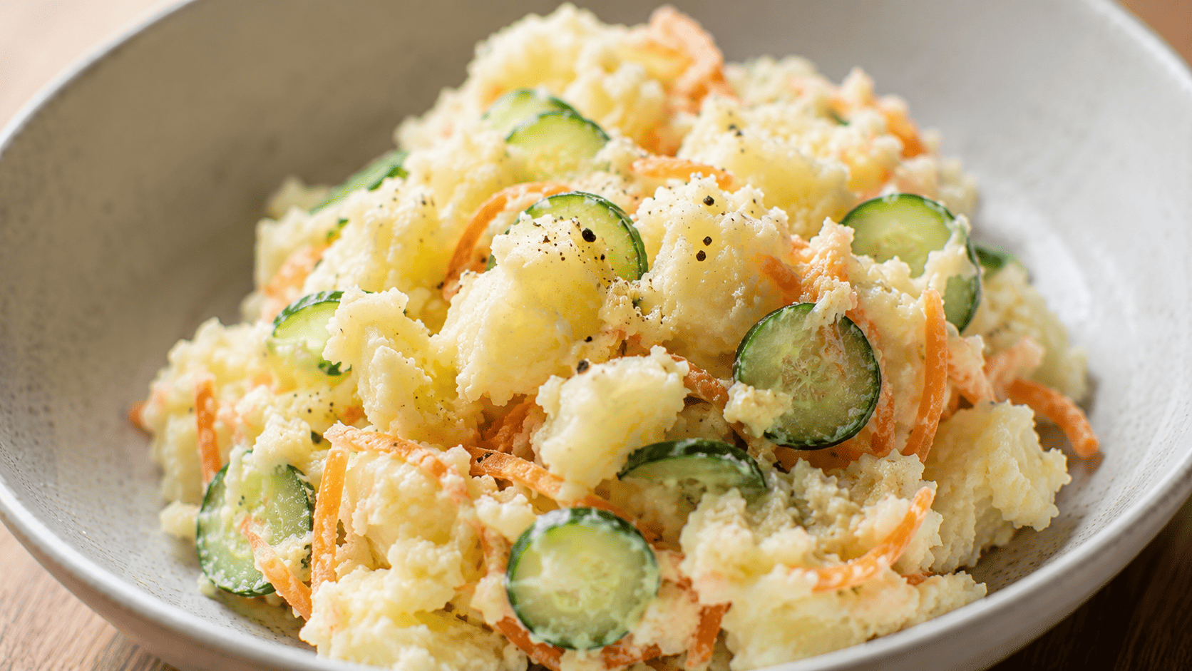 Partly-mashed Japanese-style potato salad with thin cucumber slices and shredded carrot