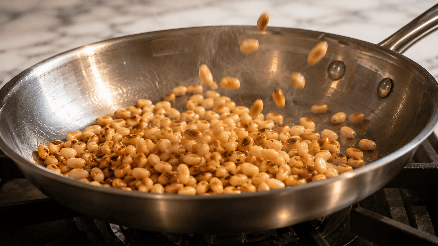Pine nuts toasting in a dry skillet until light golden
