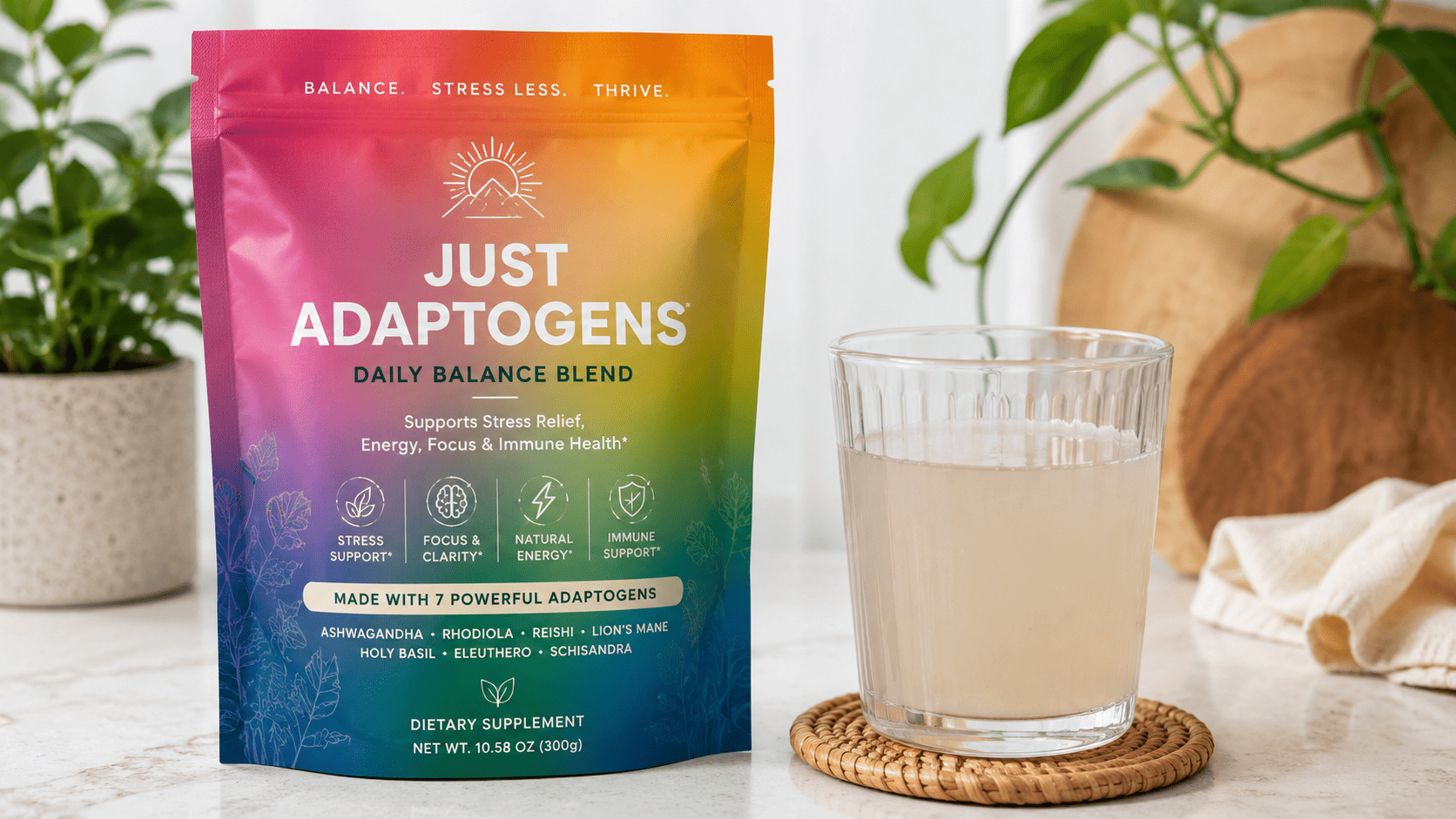A colorful adaptogen powder pouch beside a glass of cloudy water
