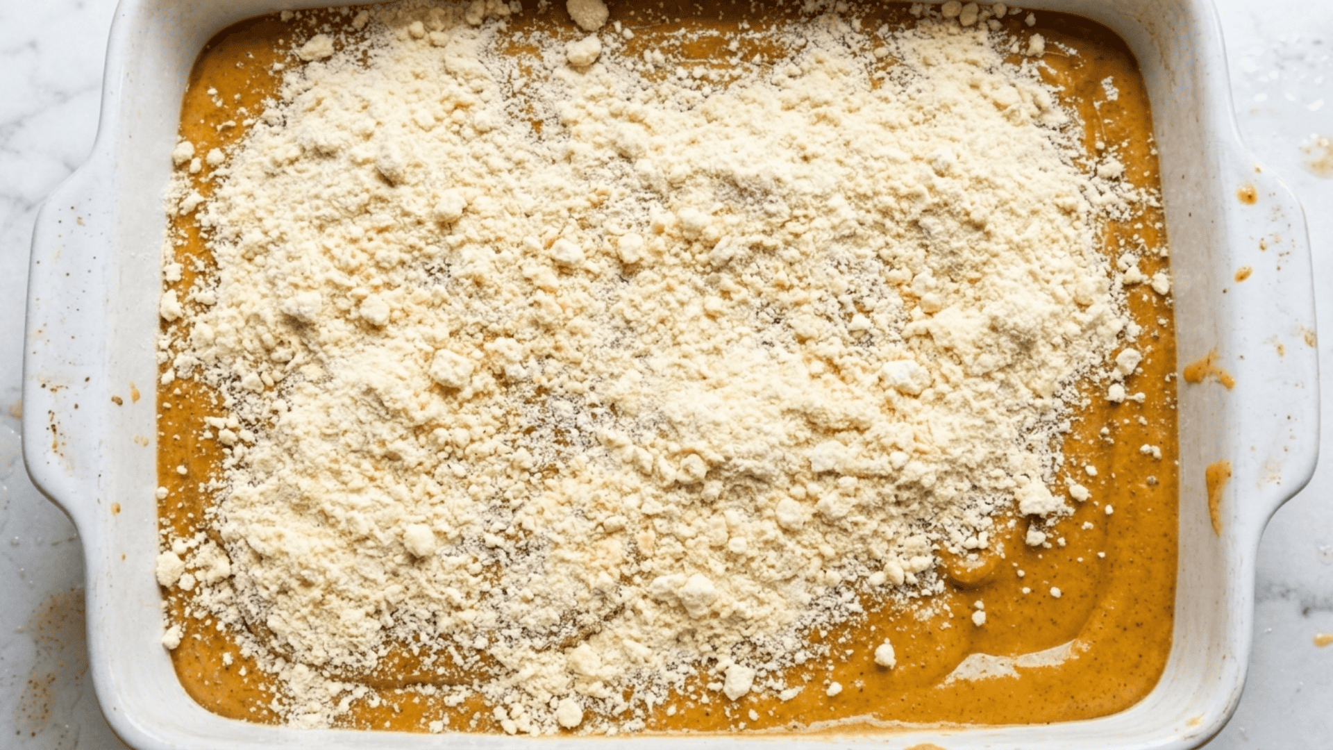 Dry yellow cake mix sprinkled evenly over the pumpkin layer